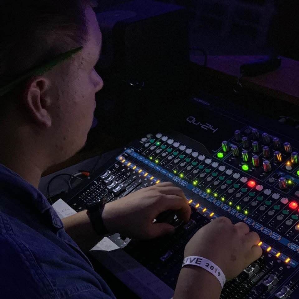 Hands on a lighting console mid-show